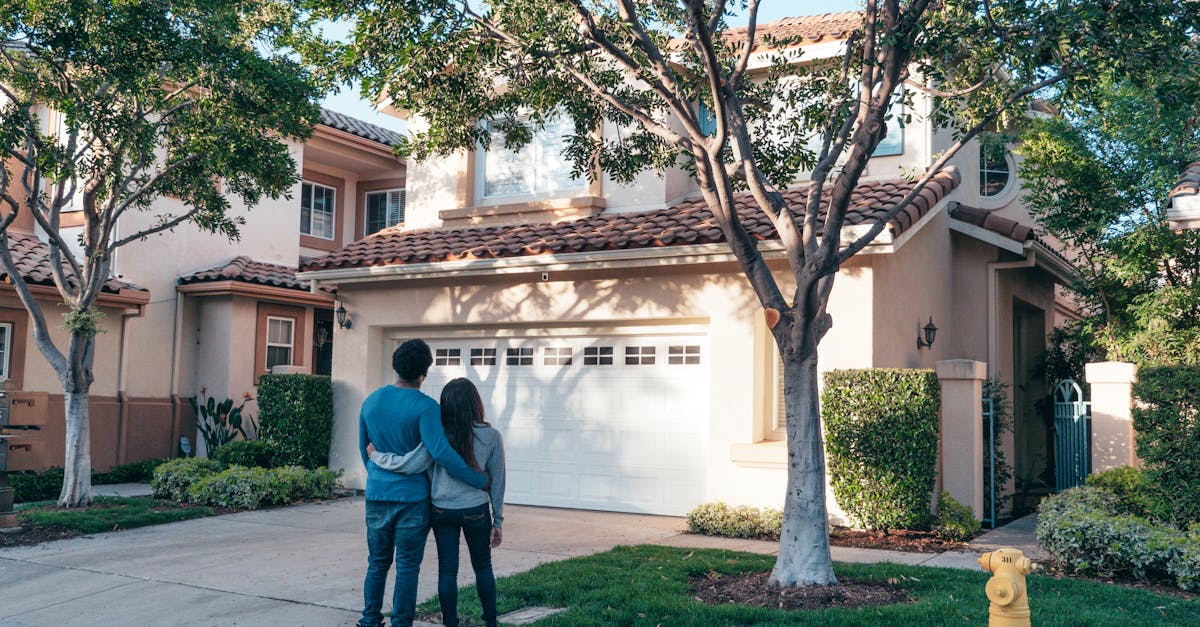 Couple hugging outside their newly purchased suburban home, showcasing togetherness and new beginnings.